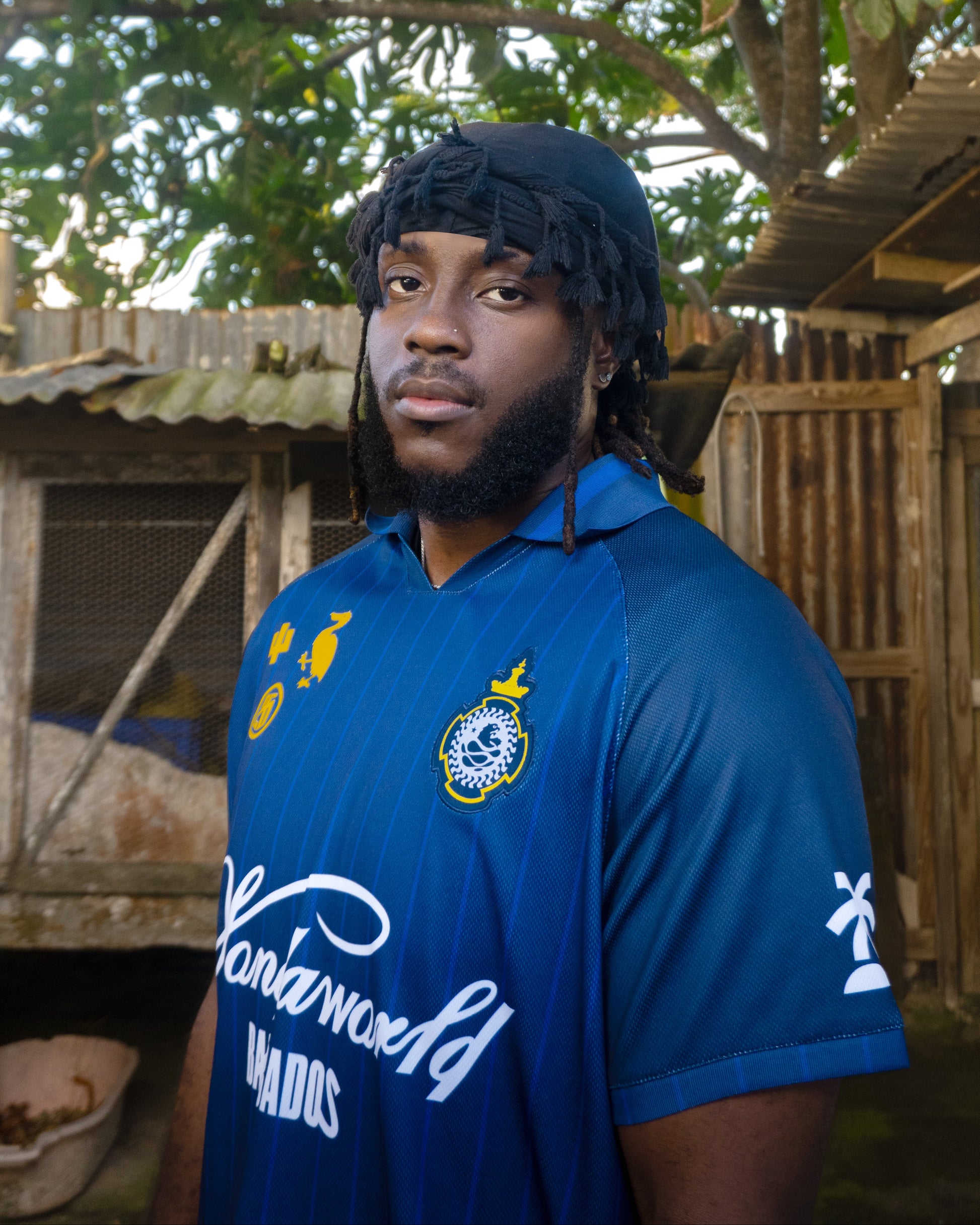 Person wearing a blue sports jersey with visible branding in an outdoor setting